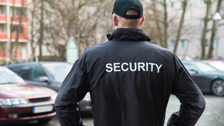 Close-up Of Male Security Guard Wearing Black Jacket